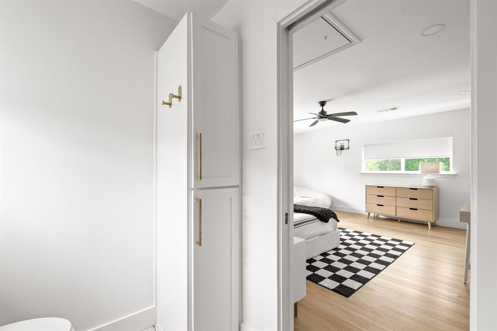Recessed lighting illuminates wood-finish flooring