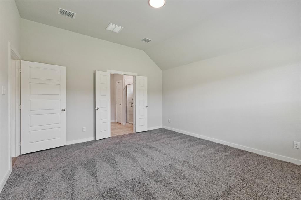 Primary bedroom in the Quartz home plan by Trophy Signature Homes – REPRESENTATIVE PHOTO