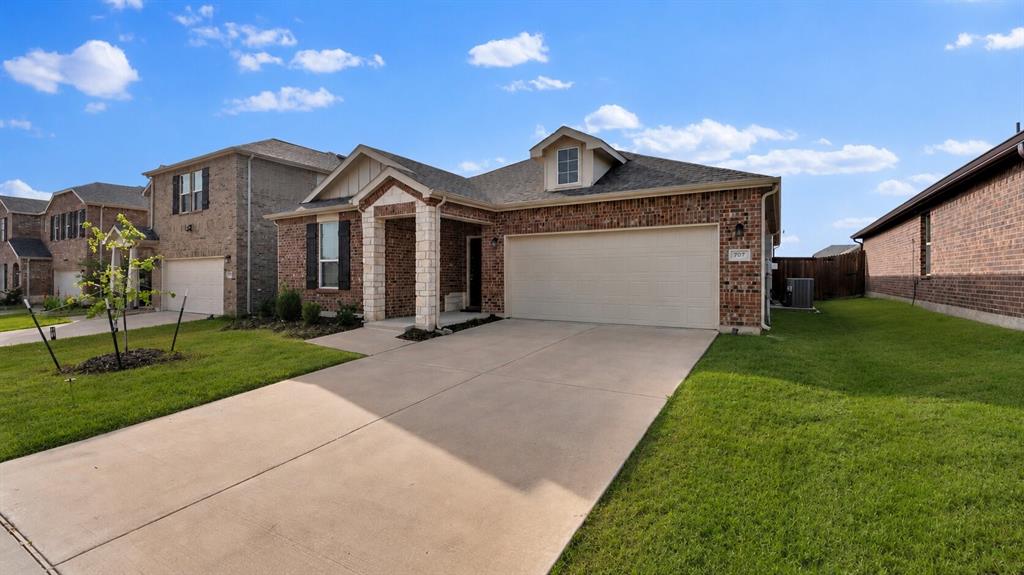 Brick exterior with stone accents and a covered entry
