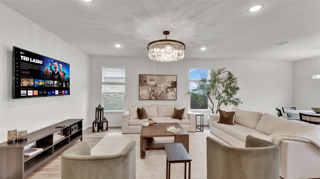 Spacious interior featuring recessed lighting, a modern chandelier, and wood-finish flooring