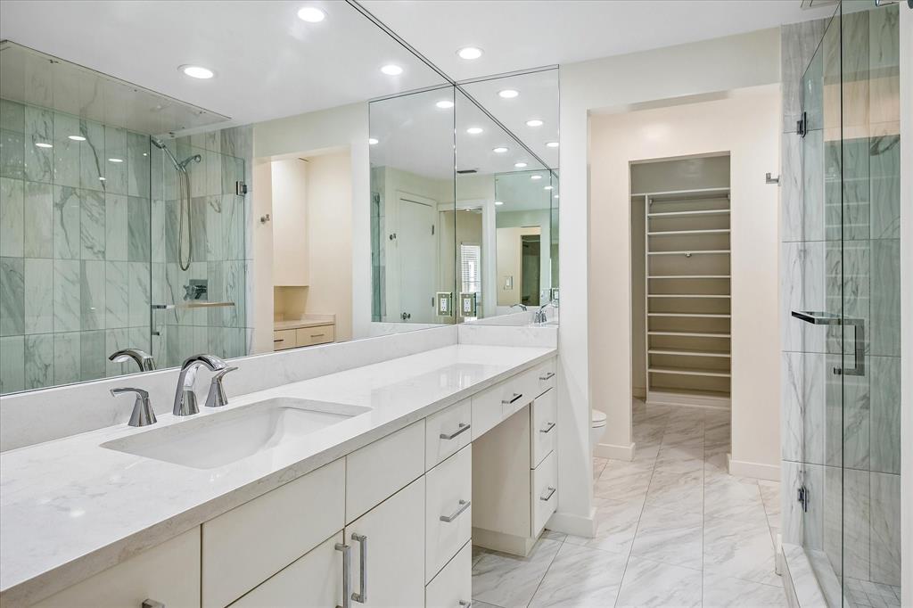 Updated ensuite primary bathroom with a vanity area.