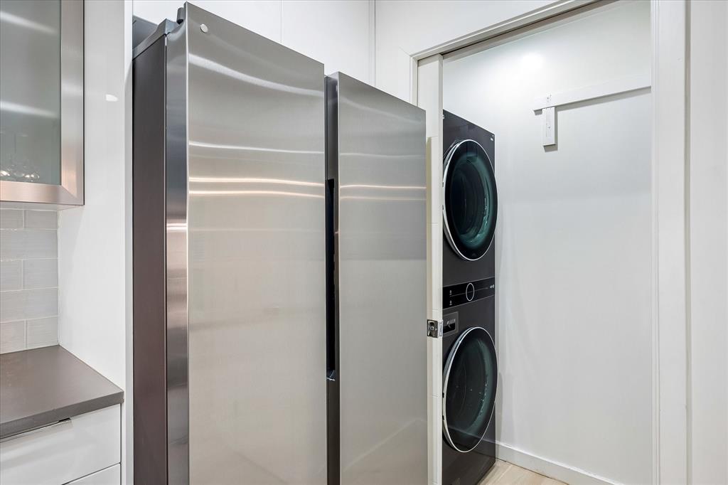 Laundry room is off of the kitchen.  LG stack washer dryer conveys.