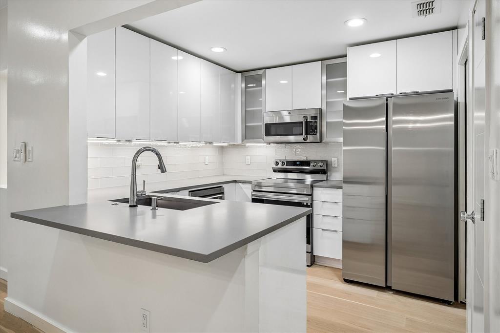 Completely updated kitchen with Kitchen Kraft acrylic cabinets.  Refrigerator conveys with the property.