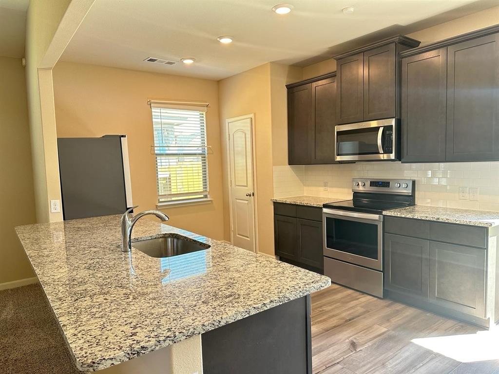 Kitchen island with a stainless steel undermount sink and chrome faucet