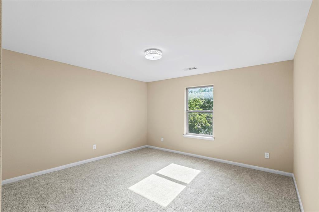 Interior room featuring beige walls, light gray carpet, and a flush mount ceiling light