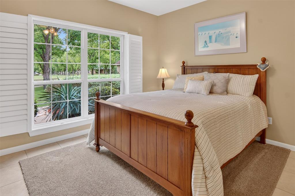 Additional guest quarters with large windows and tile flooring.
