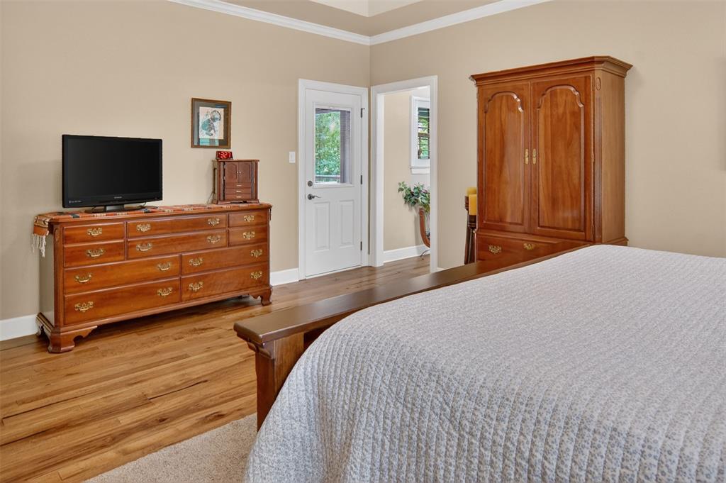 Additional view of primary bedroom with door leaving to enclosed patio and rear yard.