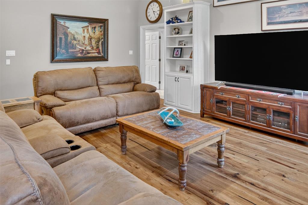 Inviting family room with wood flooring, built-ins, and fireplace. Inviting family room with wood flooring, built-ins, and fireplace.