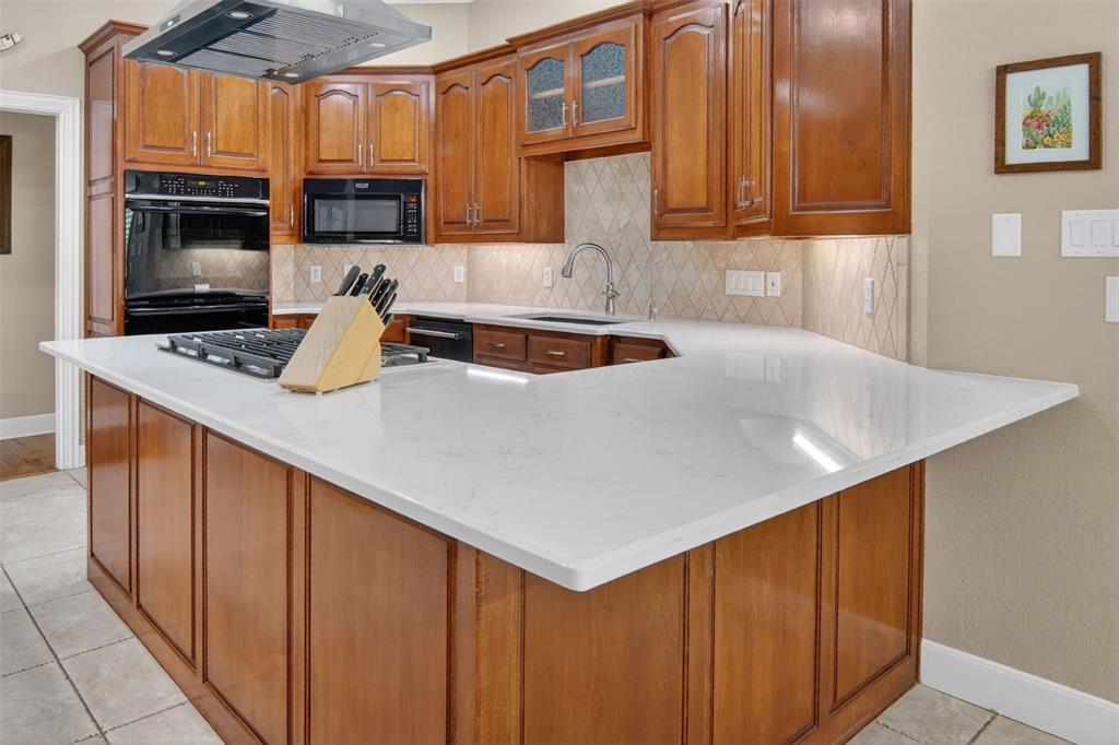 This cook's kitchen is a delight and features large island with gas cooktop, double oven, microwave, and dishwasher.