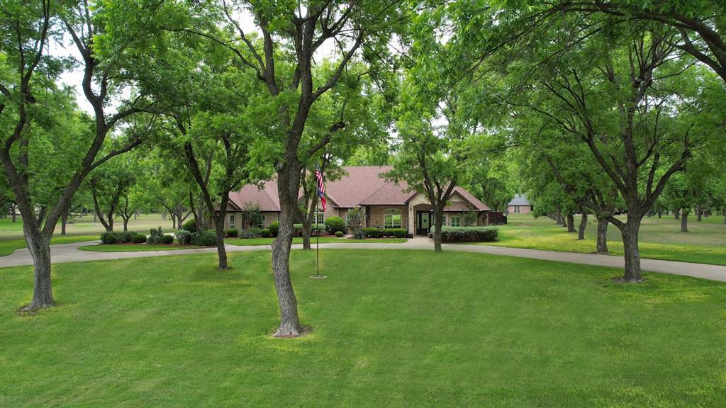 Lovely treed yard with circular drive. Lovely treed yard with circular drive.