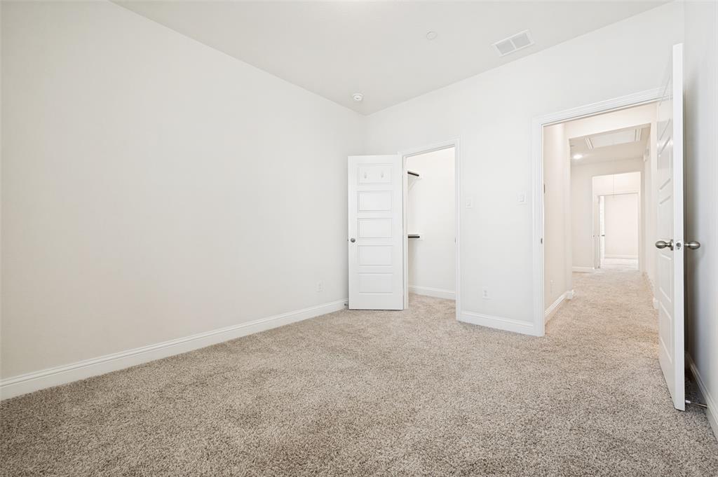Bright interior space featuring light-toned carpeting and white wall finishes