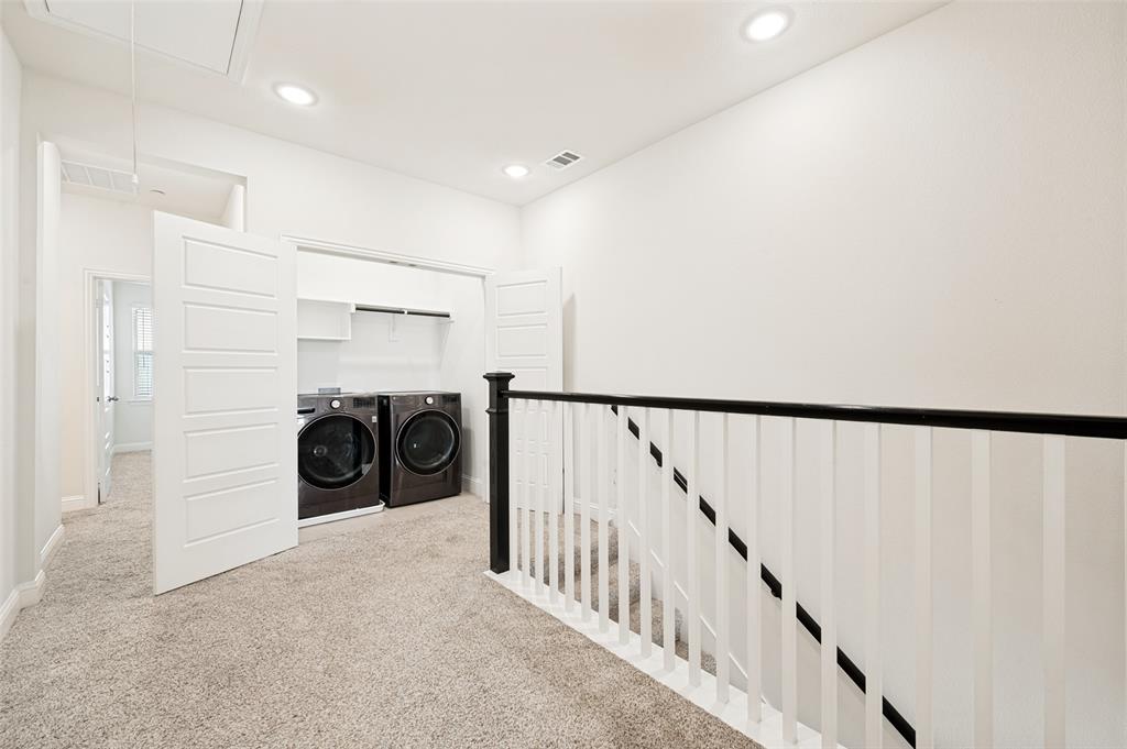 Dedicated laundry closet with front-loading appliances and shelving