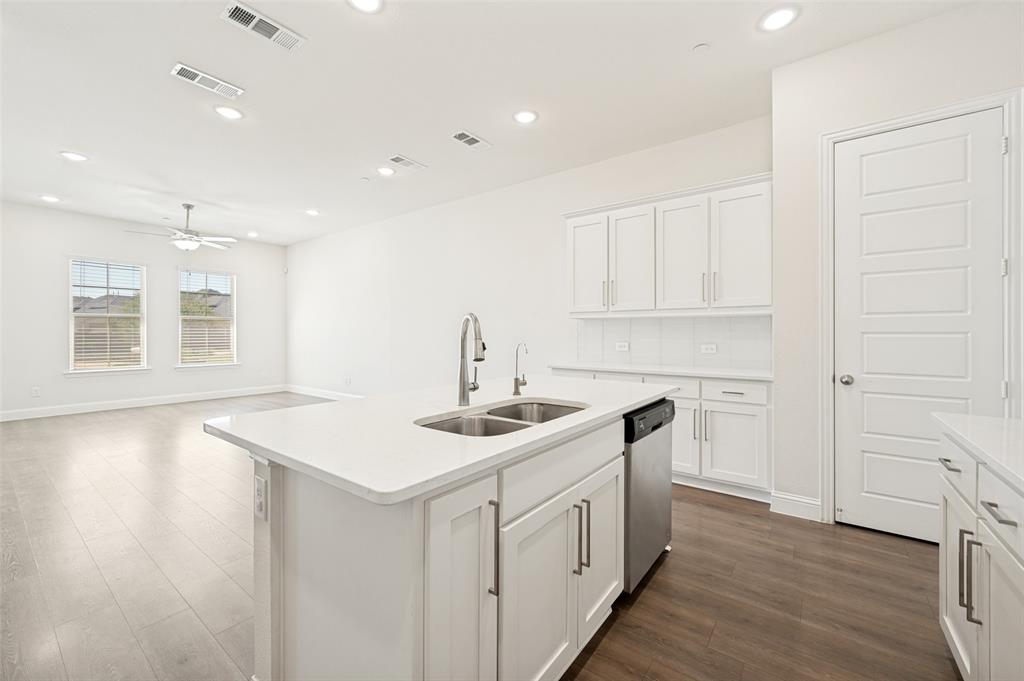 Modern kitchen island with a double basin sink and stainless steel faucet