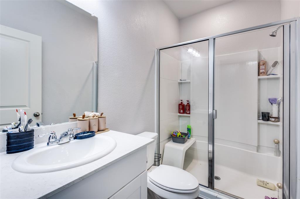 Bathroom featuring a white vanity with an undermount sink, chrome faucet, and a framed mirror