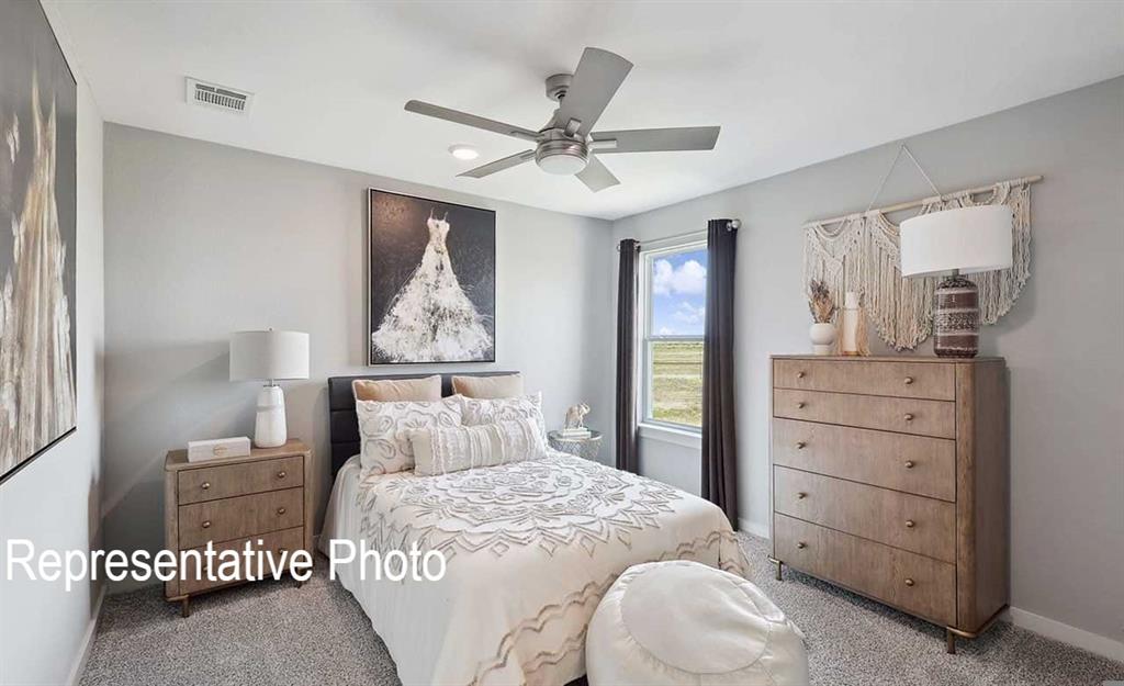 Carpeted room featuring a ceiling fan with integrated lighting, a window with dark drapes, and light gray walls