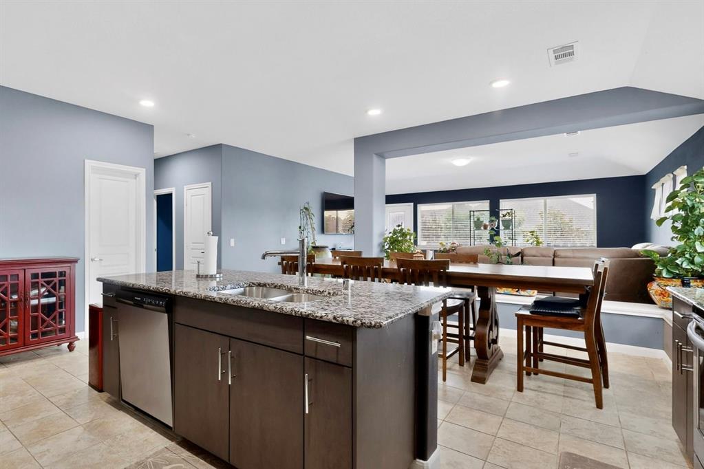 Kitchen island with granite countertop, stainless steel sink, and integrated dishwasher Kitchen island with granite countertop, stainless steel sink, and integrated dishwasher
