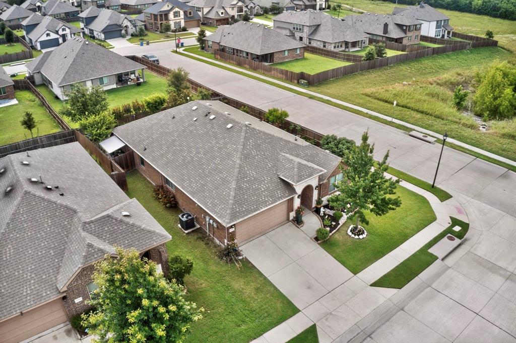 Traditional-style home featuring a brick facade, attached two-car garage, and a concrete driveway