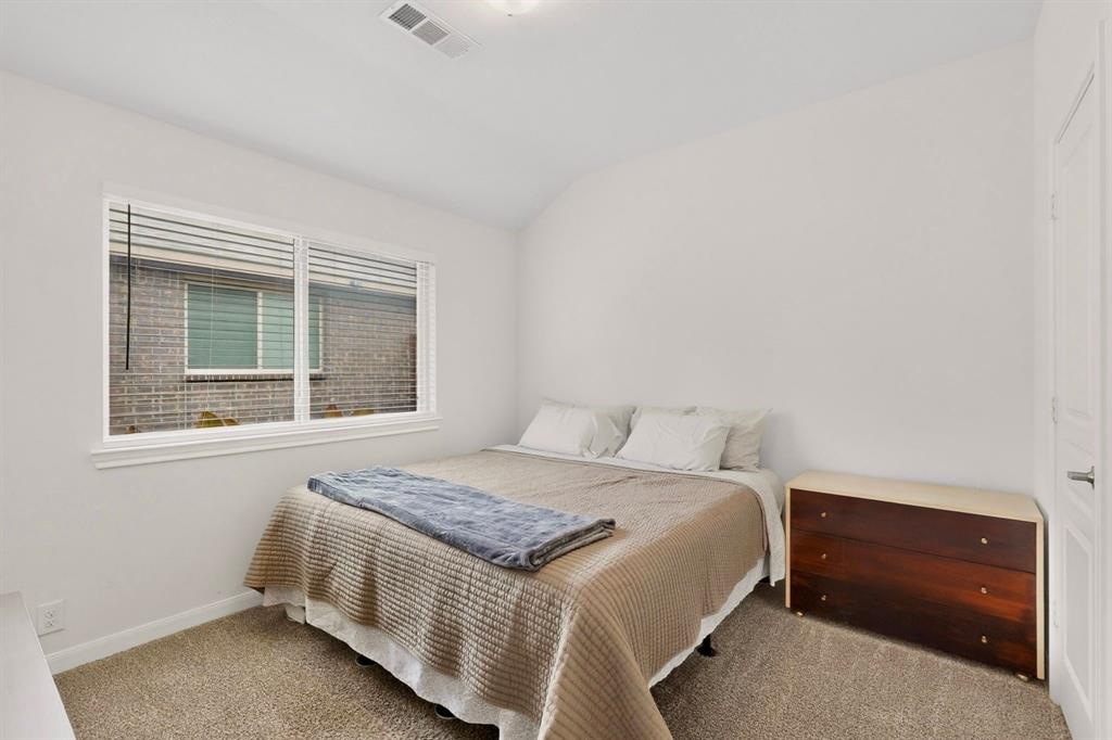 Carpeted room featuring white walls, a single window with blinds, and white trim