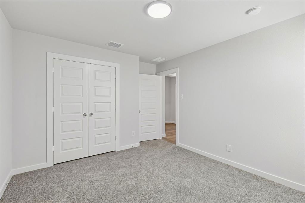 Bedroom in the Harrison home plan by Trophy Signature Homes – REPRESENTATIVE PHOTO