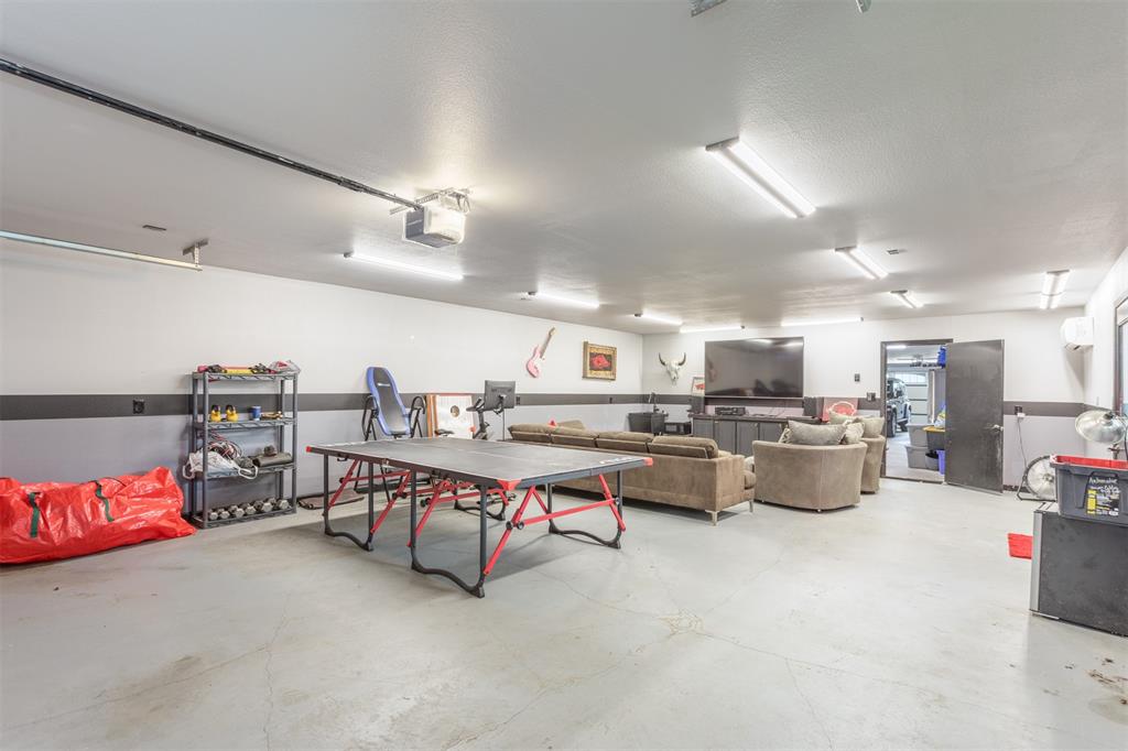 Attached workshop will house 4 cars or flex space for your man cave, kids gameroom, workout room, etc. Private ntry door to backyard along with overhead doors, built in sink, access to the home through the attached garage