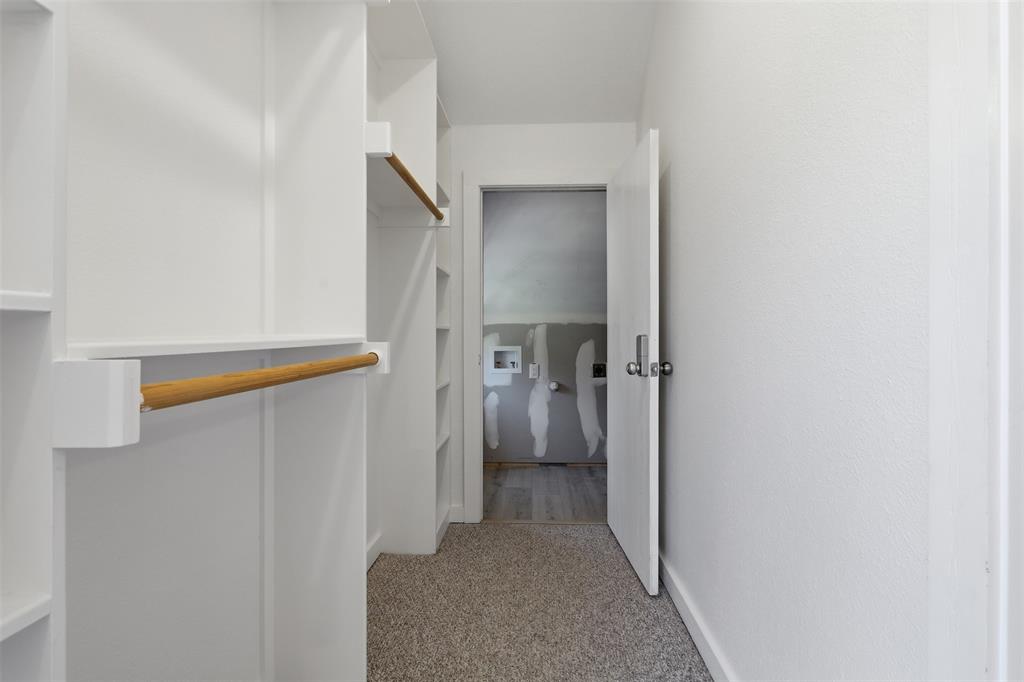 Primary closet up with private laundry in closet