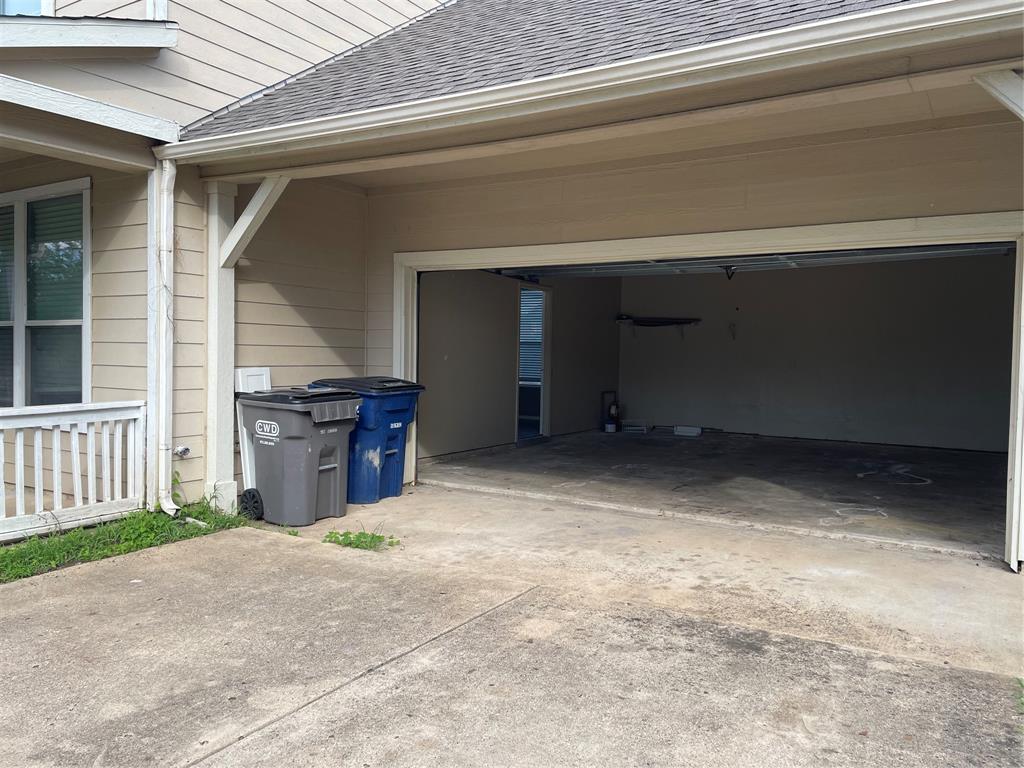 Two-car garage with concrete driveway and overhead garage door