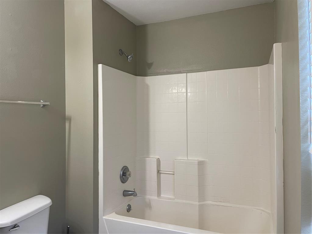 Bright white tub and shower combination with chrome fixtures