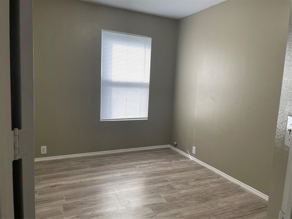 Light wood-finish flooring with white baseboards and neutral wall tones