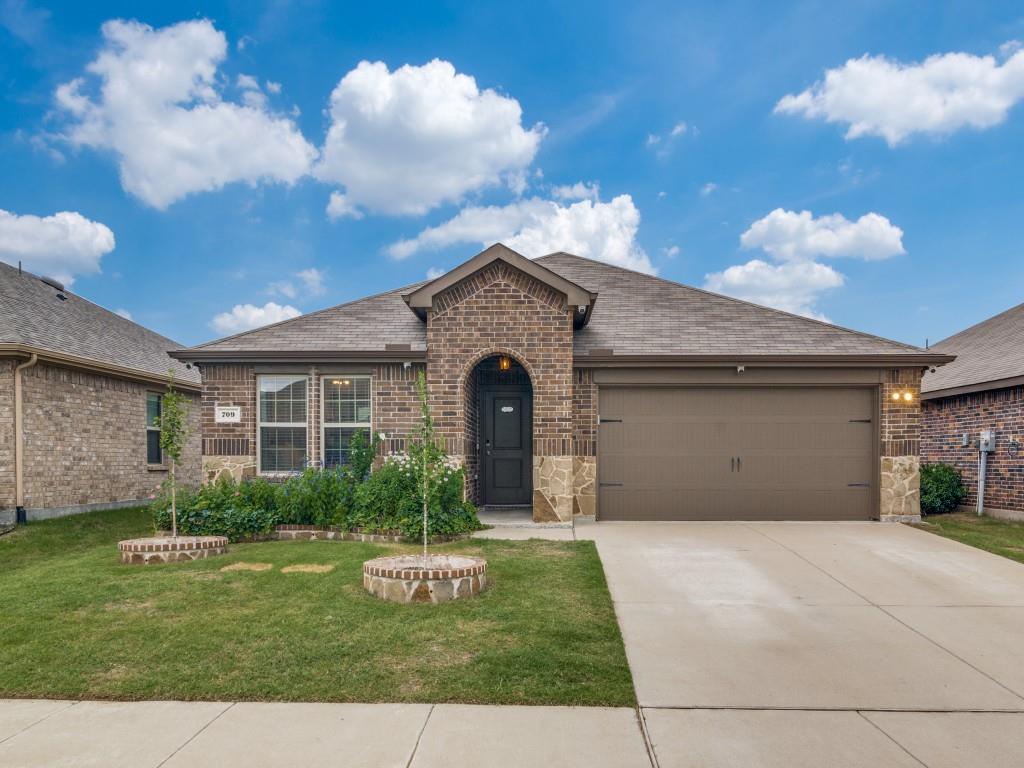 Brick exterior with stone accents and an arched entry Brick exterior with stone accents and an arched entry