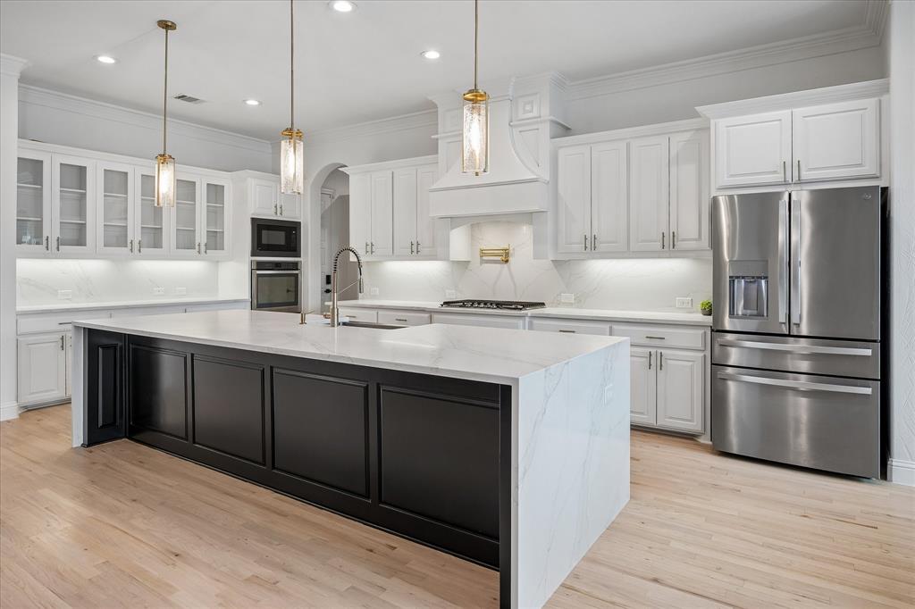 Beautiful Pendant Lights above Island, Pot Filler at cooktop and glass doors in some cabinets Beautiful Pendant Lights above Island, Pot Filler at cooktop and glass doors in some cabinets