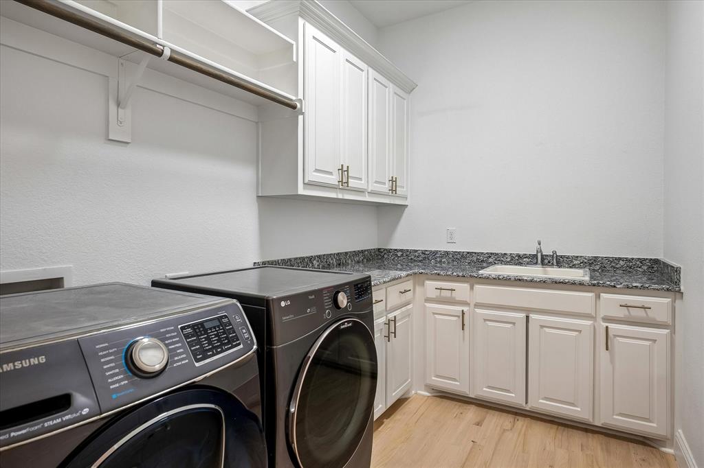 Utility Room has sink, storage and hanging bar