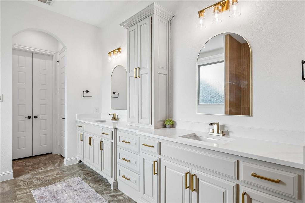 Updated bathroom with countertops, sinks, tub, shower and lighting!
