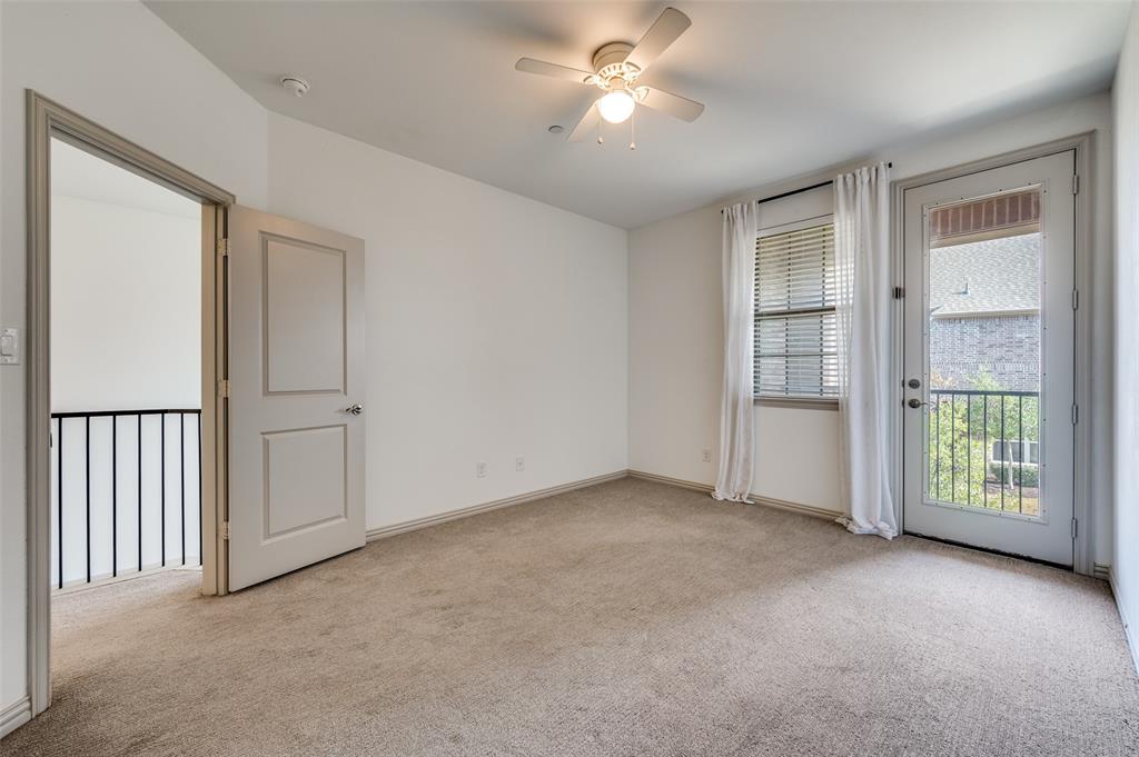 Empty upstairs bedroom or flex room featuring ceiling fan, light carpet, natural light from windows, and neutral paint, offering options for a secondary bedroom, home office, guest room, nursery, or playroom in this McKinney Texas townhome, ideal for buyers needing flexible space in a family friendly neighborhood.