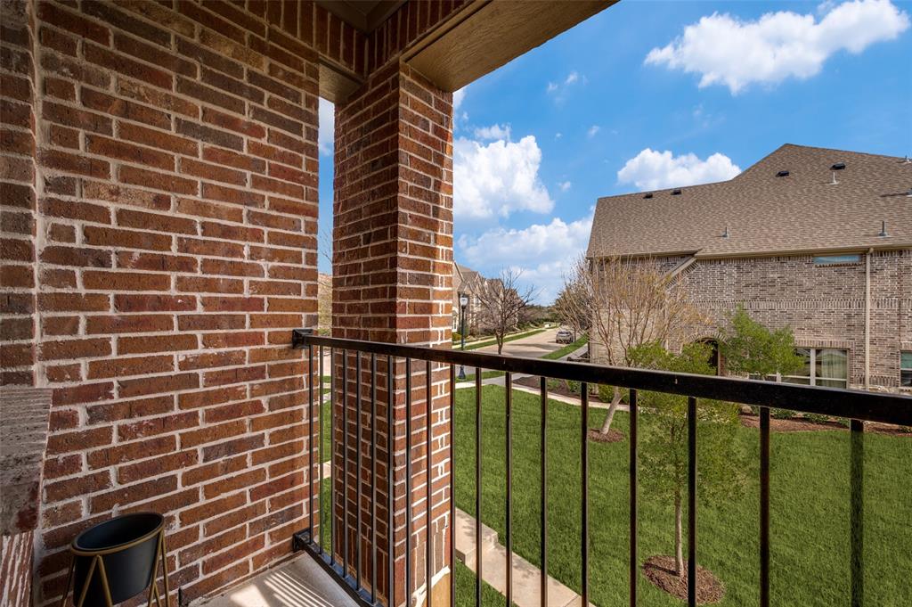 Covered balcony at 7424 Mitchell Drive McKinney Texas with brick surround and iron railing, providing private outdoor living space and neighborhood views, ideal for buyers searching for a McKinney TX townhome with balcony, outdoor seating area, and relaxing spot in a quiet Collin County subdivision. Covered balcony at 7424 Mitchell Drive McKinney Texas with brick surround and iron railing, providing private outdoor living space and neighborhood views, ideal for buyers searching for a McKinney TX townhome with balcony, outdoor seating area, and relaxing spot in a quiet Collin County subdivision.