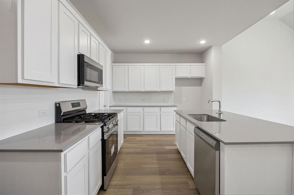 Kitchen in the Masters home plan by Trophy Signature Homes – REPRESENTATIVE PHOTO