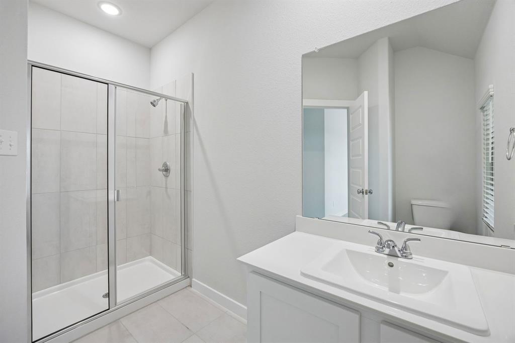 Bathroom in the Masters home plan by Trophy Signature Homes – REPRESENTATIVE PHOTO