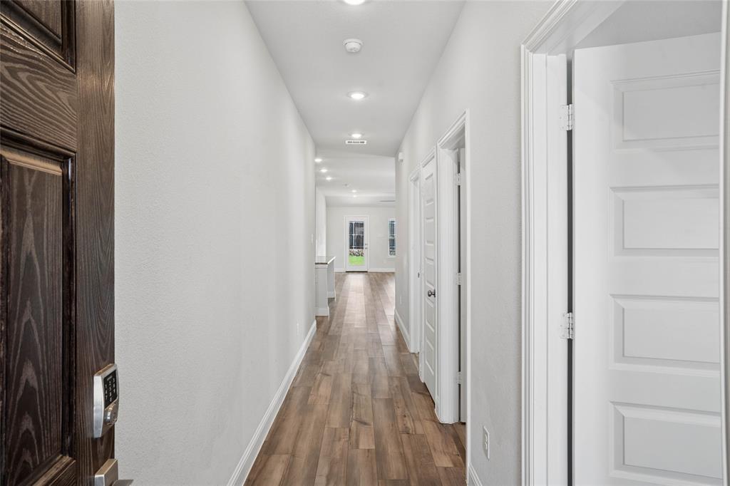 Long hallway featuring wood-finish flooring and recessed lighting Long hallway featuring wood-finish flooring and recessed lighting