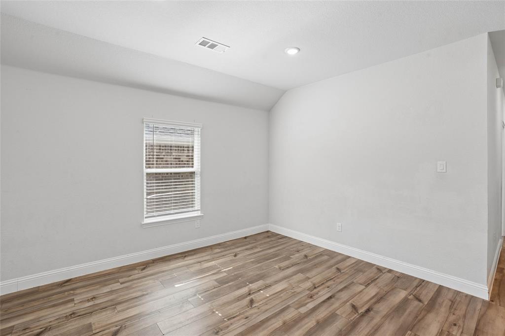 Room featuring wood-finish flooring, white baseboards, a window with blinds, recessed ceiling lighting, and light-toned walls