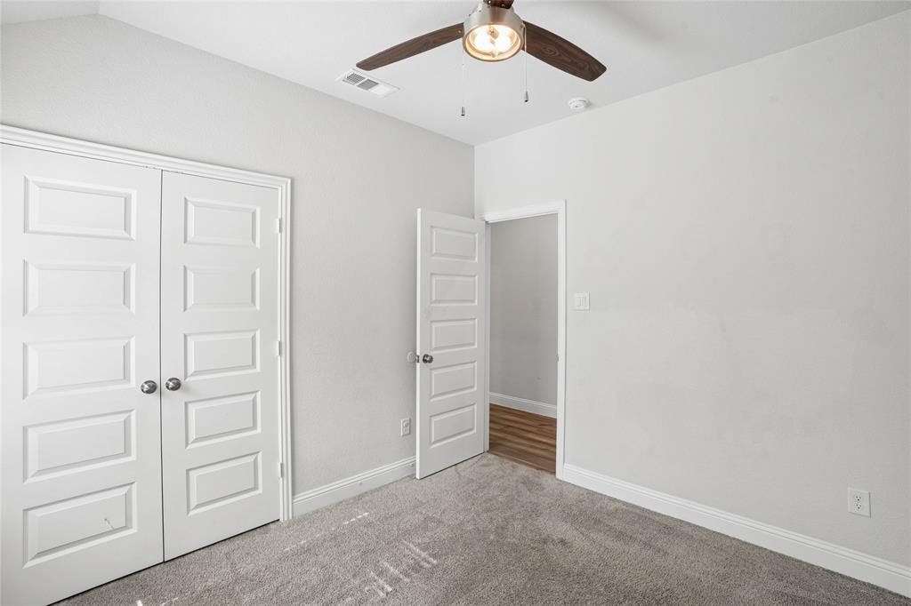 Carpeted room with light grey walls