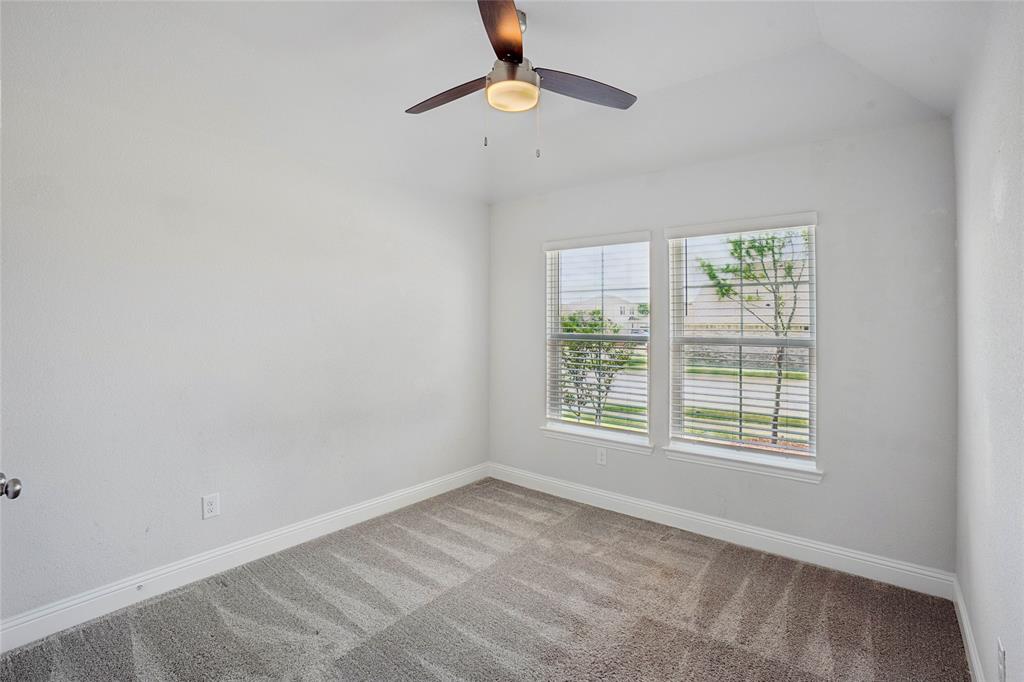 Room featuring light-toned carpeting, white walls, and a ceiling fan with integrated lighting