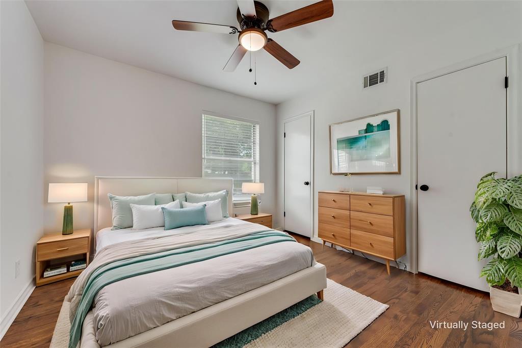 Bedroom featuring wood-finish flooring, white walls, and a ceiling fan with light fixture
