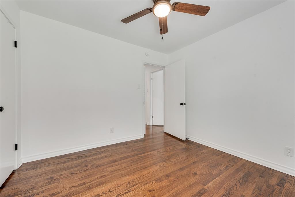 Wood-finish flooring with white baseboards