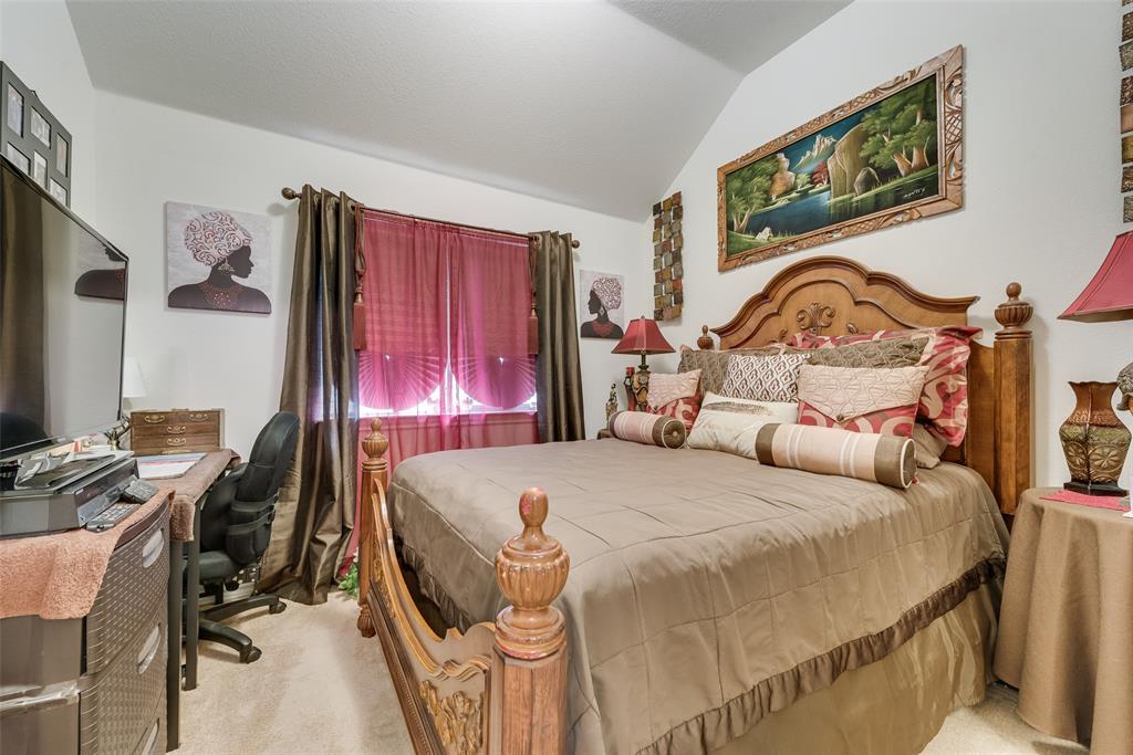 Carpeted room with a vaulted ceiling