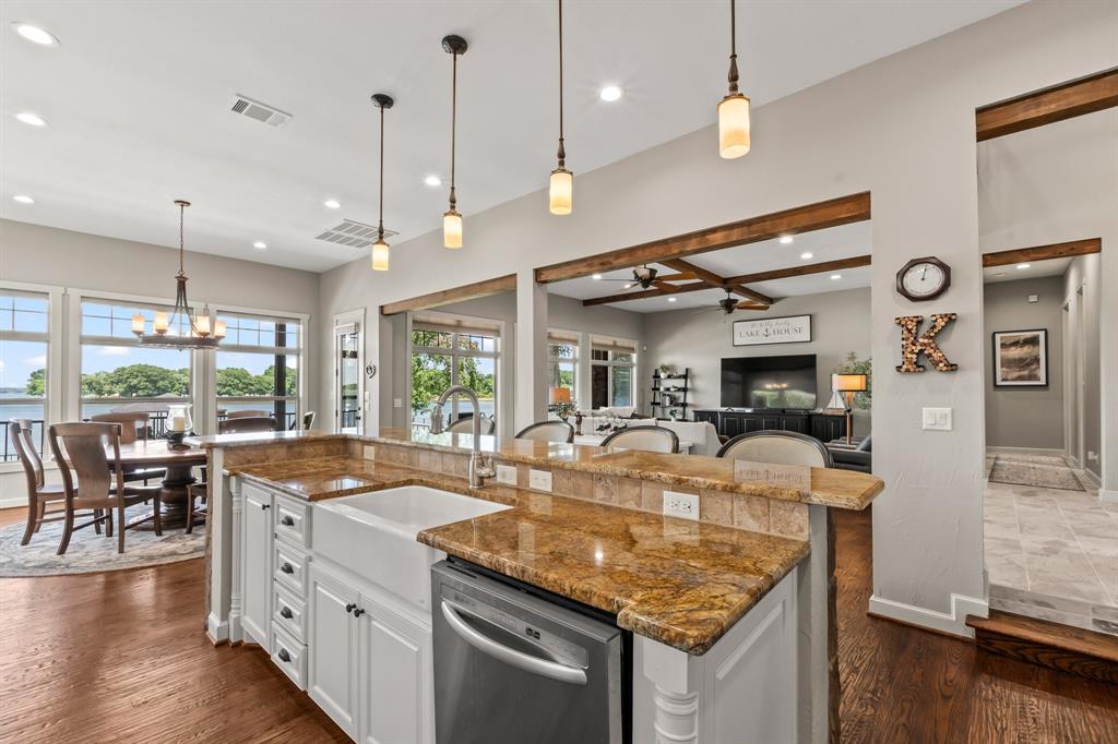 The expansive island with large single basin sink, stainless appliances, and granite countertops.