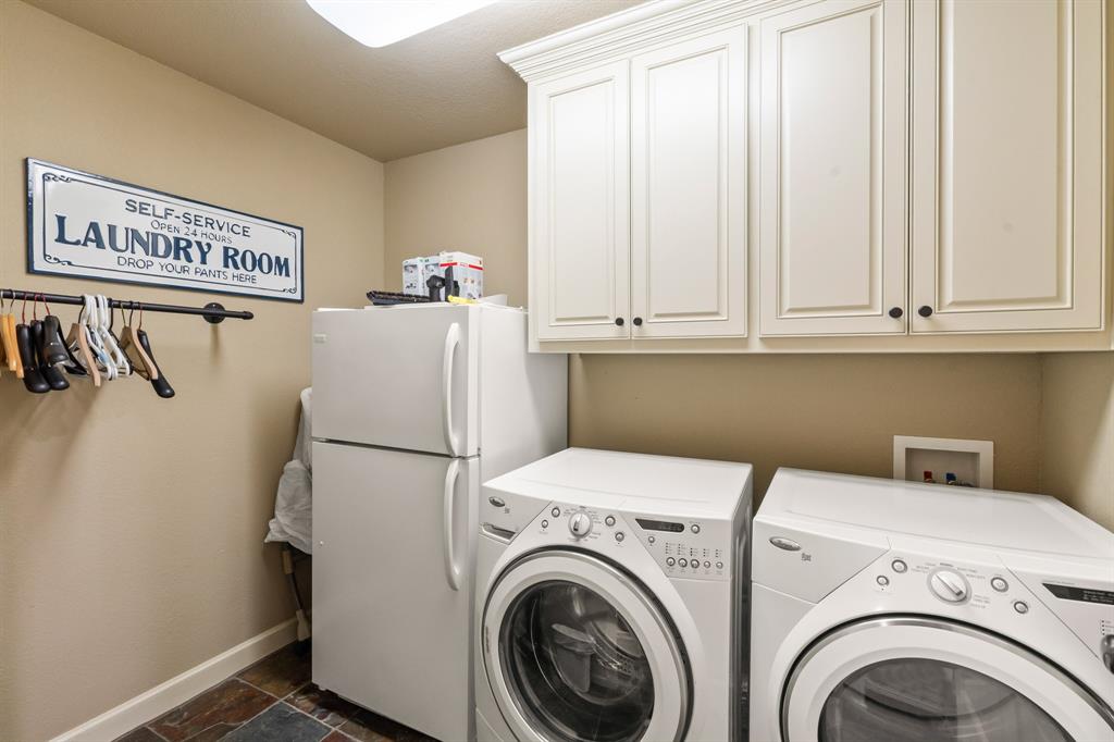 Large utility room with extra fridge.