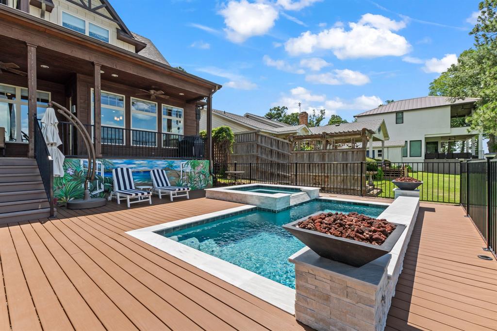 Enjoy lake life year round with the heated pool and spa framed by fire features and open water views.