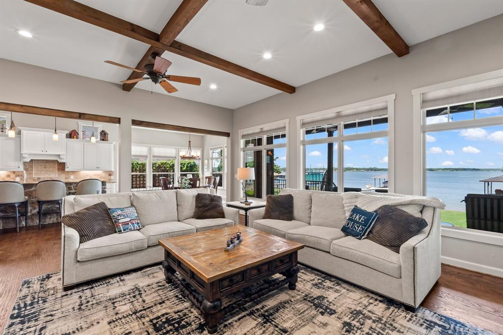 Hand-scraped wood floors, wood beams, stone accents add to the charm. New windows installed in 2024 showcasing the open-water views.
