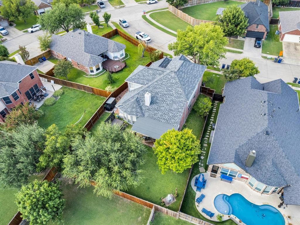 Residential property featuring a shingle roof and brick exterior