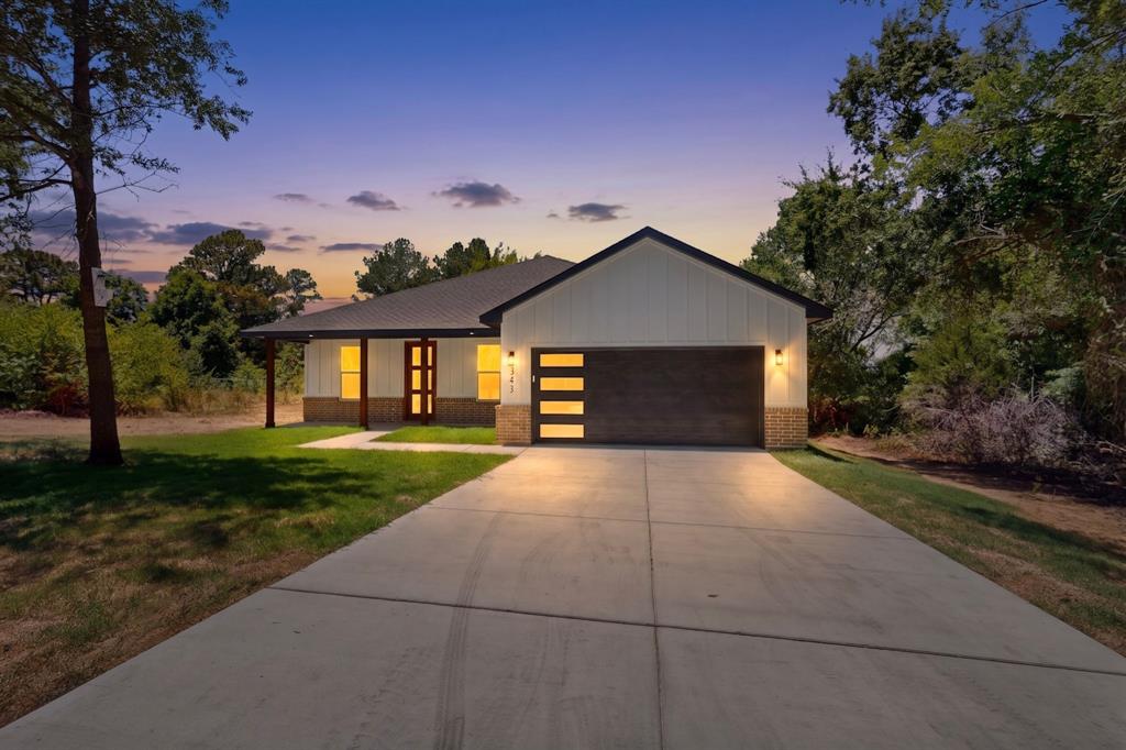 Contemporary single-story residence with a dark metal roof and board and batten siding Contemporary single-story residence with a dark metal roof and board and batten siding