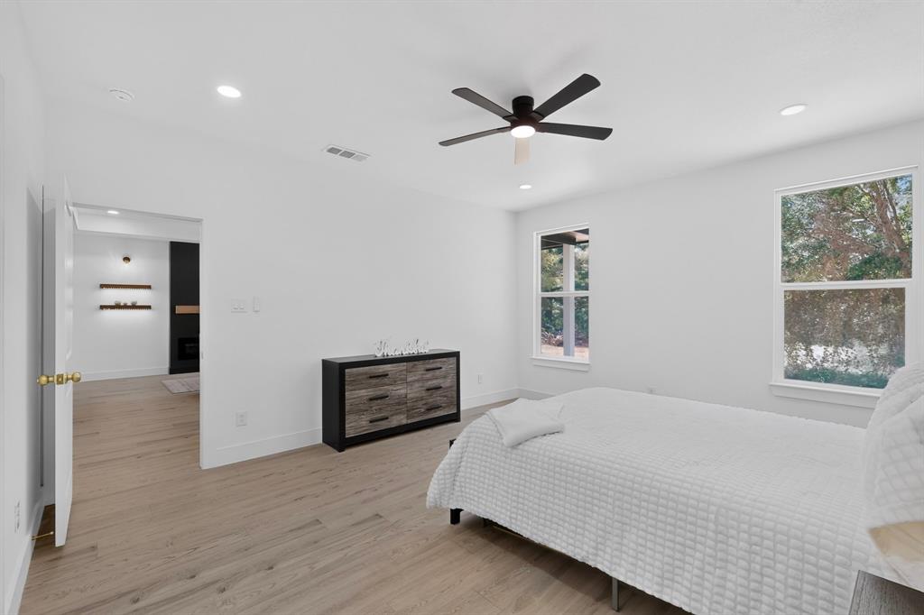 Bright room featuring wood-finish flooring, recessed lighting, and a contemporary ceiling fan